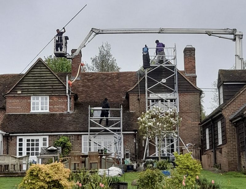 The Moss Cleaners using cherry picker and scaffolding to clean roof safely and professionally in Whitnash, Warwickshire